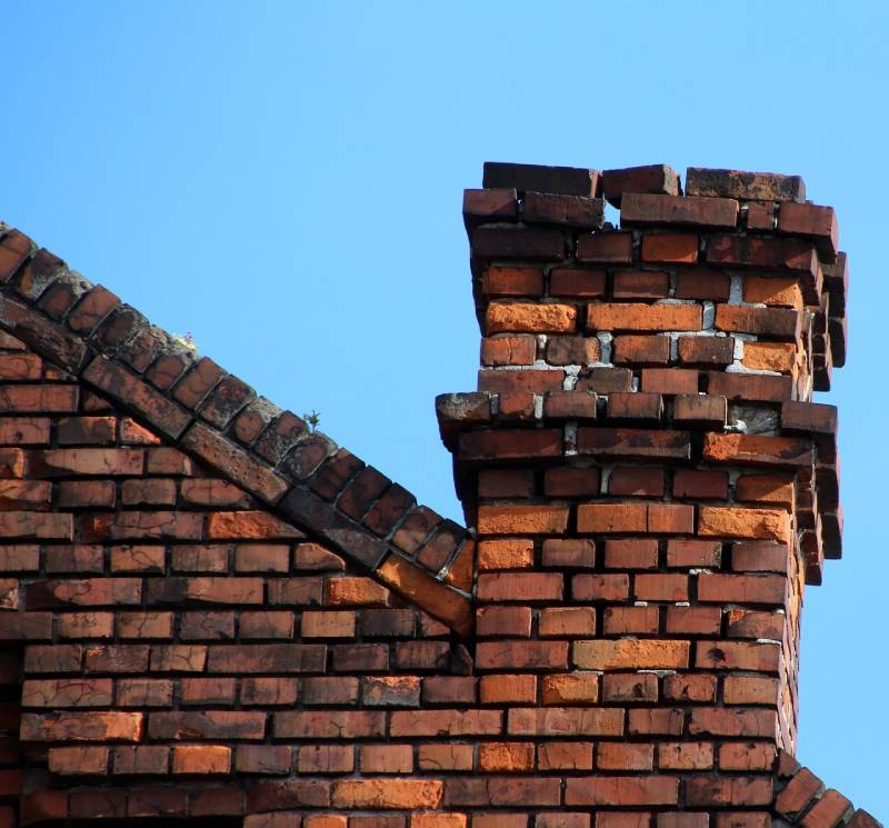 Damaged chimney on an Schaumburg home showing cracks and missing mortar